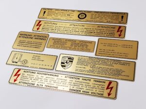 78 porsche 928 us gold metal foil sticker decal 92870116302 high voltage 92800610500 firing order 92800610105 emissions control 92800610300 ignition timing 92870115102 fan warning 9287015302 intensive washer 92800650800 tire pressure 92800650500 9287015502 battery cover 92870115702 spare tire pressure 92870115703
